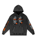 Snow washed loose cotton hoodie in black with black, white, and orange portrait artwork