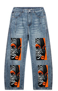 Unisex vintage wash barrel leg denim jeans with black, white, and orange portrait artwork on the front